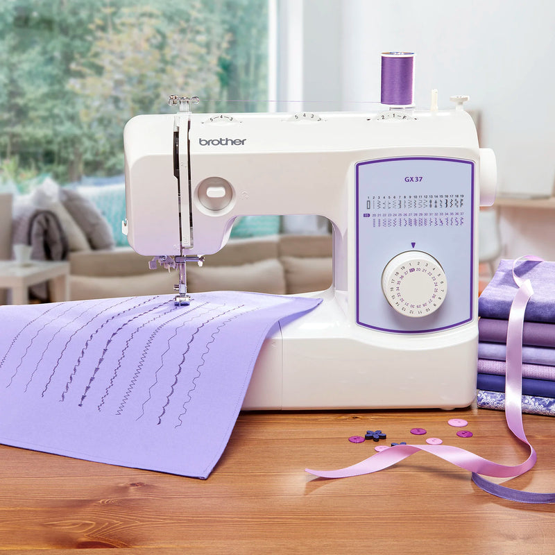 Brother sewing machine on a wooden table with fabric and ribbons in a home setting