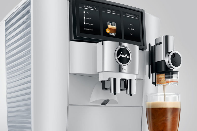 Modern coffee machine with a glass of coffee on a white background